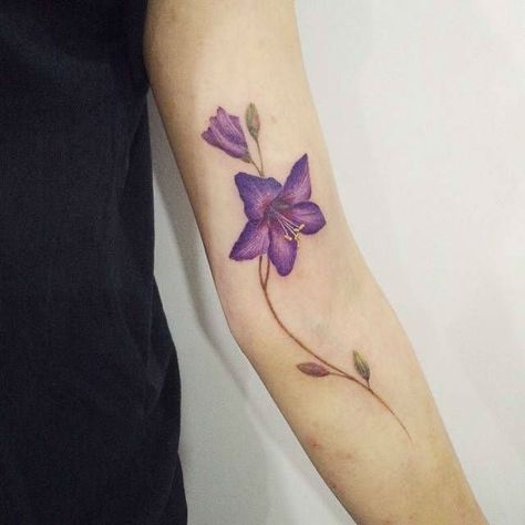 24 Symbolic Lily Tattoo Ideas Violet Flower Tattoo, Violet Flower Tattoos, Sunflower Tattoo Thigh, Delicate Flower Tattoo, Violet Tattoo, Sunflower Tattoo Sleeve, Sunflower Tattoo Shoulder, Purple Lily, Flower Tattoo Back