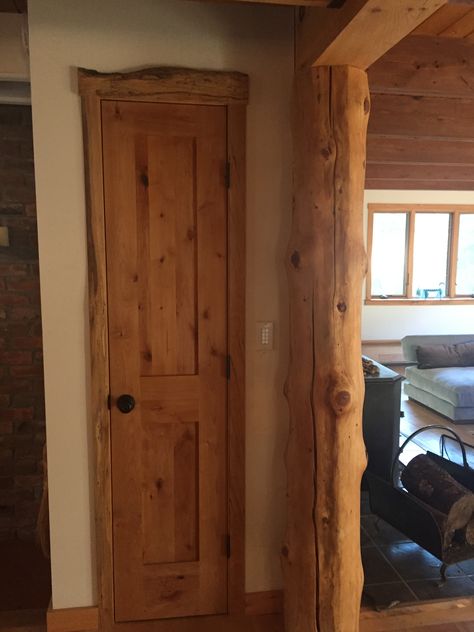 This is the door to the utility closet on the main floor, which fits between kitchen and living room.   It is a nice mix of a regular factory-made door with trim pieces that feature native (right from the property) wood, still showing its live edge.  The wall colors need to change from their basic white, but the wood trim will hopefully be there forever. Live Edge Door Trim, Live Edge Baseboard Trim, Live Edge Trim Molding, Live Edge Baseboard, Live Edge Trim, Wood Hobbies, Fake Beam, Back Porch Makeover, Wood Door Frame