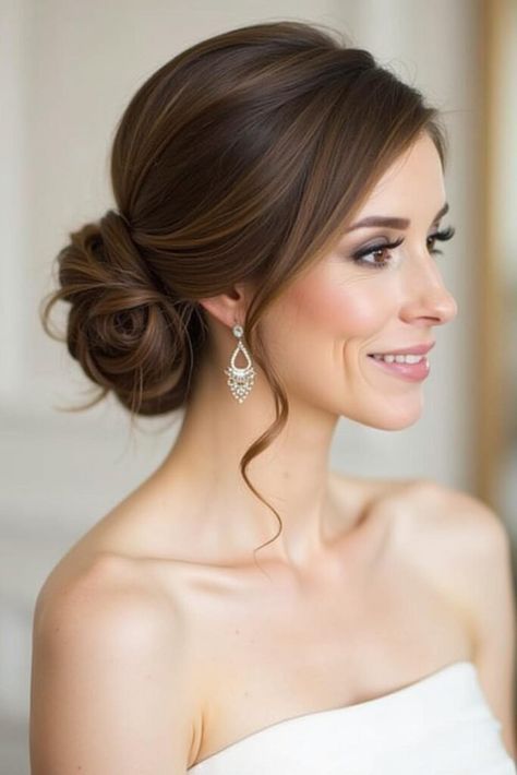 38 Bun Hairstyles Ideas 2025 - Fashion Trend Hacks Bride Hairstyles Low Updo, Loose Low Bun Updo, Wedding Hairstyles Side Bun, Bridal Hair Updo Low Bun, Grecian Updo Wedding, Bridal Simple Updo, Low Messy Wedding Bun, Smooth Updo Wedding, Bridal Updo With Veil Brown Hair