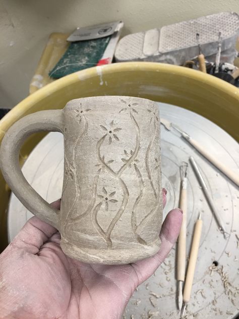 Greenware with hand carved flowers. Textured Clay Mugs, Clay Pot Carving Designs, Ceramic Flower Carving, Carved Flowers Pottery, Ceramic Mug Carving, Ceramic Pitchers Ideas Handmade Pottery, Pottery Carving Ideas Simple, Mug Carving Ideas, Carved Ceramic Mugs