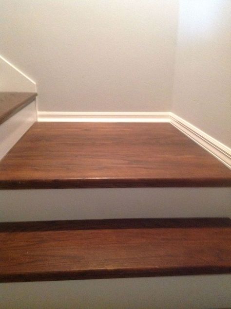 How to redo stairs for cheap - Give your outdated staircase a gorgeous new look! This is a cheater version (little scraping / little painting) that uses wood caps on top of your existing stairs. Redo Stairs, Wood Stair Treads, Pergo Laminate, Escalier Design, Diy Hack, Wood And White, Staircase Makeover, Hallway Flooring, Wood Staircase