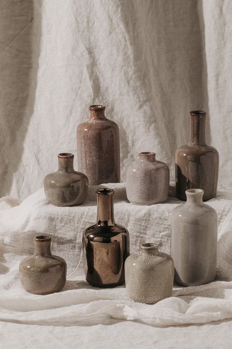 This octet of petite stoneware vases comes in a variety of shapes and sizes. Their coordinating designs make them perfect accents to spread throughout a room in small groupings. To accent a shelving unit, scatter them in a combination of pairs and trios on different levels of shelves. ✦ Measure between 2-3/4 inches tall - 5-1/2 inches tall ✦ Each vase will vary in color *Set of 8 Stoneware Vases, Ceramic Bud Vases, Cement Candle Holders, Tincture Bottles, Ceramics Collection, Cement Candle, Child Of Wild, Brown Vase, Lifestyle Shoot