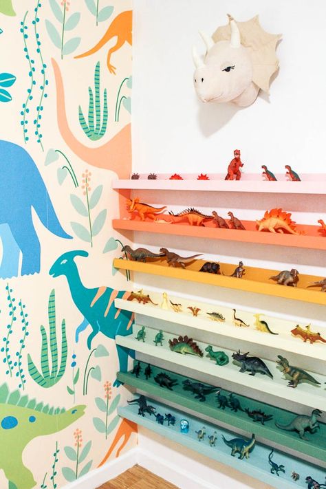 diy dinosaur shelf. Do you have a kid's room and need some toy storage ideas? I made rainbow dino ledges for my boy's bedroom. Childen's books would also work on these shelves. Click through for the full tutorial. Dinosaur Shelf, Boys Dinosaur Bedroom, Bilik Perempuan, Dinosaur Kids Room, Toy Storage Ideas, Diy Dinosaur, Dinosaur Room Decor, Kids Bedroom Storage, Dinosaur Bedroom