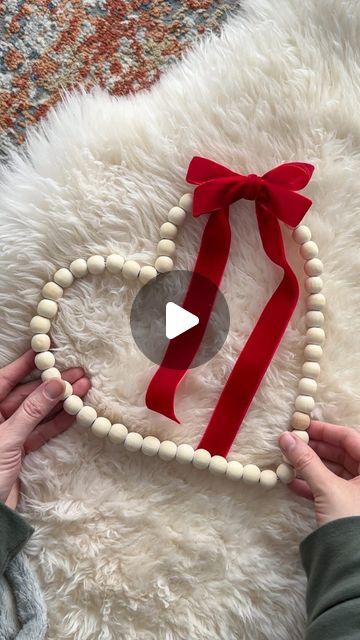 Annelise on Instagram: "🎀❤️ DIY Dollar Tree Bead Heart Wreath ❤️🎀 This is the easiest DIY wreath you’ll make! What you’ll need: 🔨💕 • Round bead wreath from @dollartree • Pliers • Ribbon for a bow • Wire to tie the bow on How to make it: 🫶🏻 • Use pliers to open the wreath form and remove one bead. Close it clamping the wire tight. • Shape the wreath into a heart. Position the opening on the side to cover it with the bow. • Secure a bow on with floral wire • Hang it up and make your friends believe you spent way more than a few $ to make it. 😉 #diy #dollartree #dollartreediy #dollartreewreath #dollartreevalentines #beadwreath #woodbeads #heart #heartwreath #budgetfriendly #crafts #valentinesdiy #valentinesday" Diy Flower Wreath Wire Frame, Wire Heart Wreath, Heart Wreaths, Bead Wreath, Bead Heart, Easy Diy Wreaths, Wire Wreath Frame, Valentine Ideas, Heart Wreath