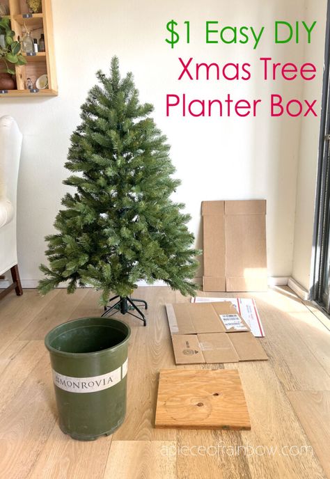 Easy $1 DIY elevated Christmas tree box stand to make a tree taller in small space home decor. Modern rustic wood planter made with cardboard! - A Piece of Rainbow, Christmas decorations, Christmas trees, home decor, holiday, hacks, boho, farmhouse, elegant, beautiful Making Christmas Tree Taller, Make Your Tree Taller, Christmas Tree Stands Diy, Make Tree Taller, Diy Tree Stand Christmas, Raised Christmas Tree, Artificial Christmas Tree Stand Diy, How To Make Christmas Tree Taller, Elevated Christmas Tree