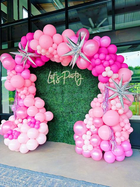 Shades of pink latex balloons tied into a garland and attached to greenery backdrop in shape of an arch with neon sign that reads “lets party” placed in the middle. Created and assembled by Party on Butler in Lawrenceville (Pittsburgh), Pennsylvania Balloon Arch Greenery, Arch With Neon Sign, 13 Shades Of Pink Party, Birthday Balloon Arch Hot Pink, Fuschia Pink Balloon Garland, Barbie Graduation, Lawrenceville Pittsburgh, Hot Pink And Light Pink Balloon Arch, Barbie Themed Baloon Arch Kit