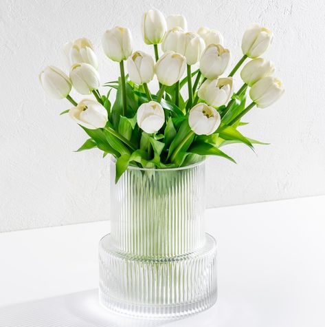 PRICES MAY VARY. HIGH QUALITY: Our quarter inch thick, waterproof, clear vases are custom designed to ensure they are durable and flawless. The base is half an inch thick. We’ve also hand selected and customized quality tulip stems so that they are sturdy and long lasting. ULTRA REALISTIC: Although It is impossible to beat nature, we nonetheless put in utmost efforts to produce the most realistic looking tulips available, in both style and color to match authentic freshly picked tulips. The colo Office Shelf Decor, Clear Flower Vase, Fake Tulips, Faux Tulips, Ribbed Glass Vase, Short Vase, Artificial Tulips, Fluted Vase, Office Shelf