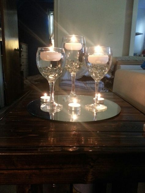 Wine glasses for centerpieces with floating candles, but instead of the tealights on the mirror with them maybe have votive candles in clear holders. Diy Table Centerpieces For Home, Glass Candle Centerpieces, Wine Centerpiece, Wine Glass Centerpieces, Table Centerpieces For Home, Table Centerpieces Diy, Floating Candle Centerpieces, Kitchen Table Centerpiece, Wine Glass Candle