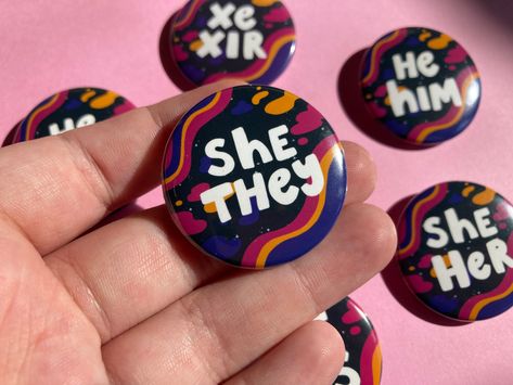 "Cute pronoun pin buttons with a space aesthetic, available in 10 options! -Made by a queer trans artist -1.5\" handpressed buttons -He/him, she/her, she/they, they/she, he/they, they/he, xe/xir, it/its, and they/them options available -Colors may vary on screen This listing is not intended for reselling. Please contact shop owner for wholesale details, or visit my wholesale shop!" Pin Button Design, Pronoun Pins, Holographic Film, Space Aesthetic, Button Maker, Student Christmas Gifts, Punk Patches, Diy Pins, Goth Aesthetic