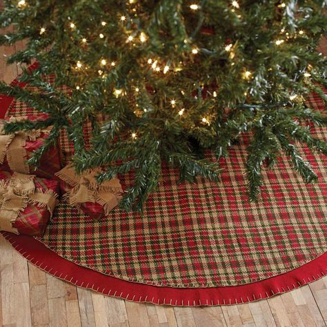 Claren Tree Skirt 48" Tree skirts add a touch of style beneath your tree when you decorate for the holidays. This Claren Tree skirt is perfect for bringing a woodsy, country look to your room when you use it to complete your Christmas Tree.. It measures 48" in diameter. The front displays a cherry red, forest green, and khaki plaid woven fabric with detailed stitching. There is a 2" cherry red felt border that also displays detailed stitching to complete the simple charm of this accent. There ar Rustic Tree Skirt, Rustic Christmas Tree Skirts, Plaid Tree Skirt, Fringe Tree, Glam Christmas Decor, Vhc Brands, Traditional Christmas Decorations, Country Christmas Decorations, Rustic Christmas Tree