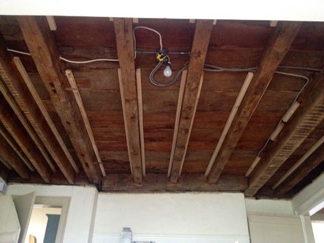 A DIY tutorial on how to expose wood beams in an antique post and beam farmhouse. See a complete ceiling makeover to reveal original wood beams. Post And Beam Farmhouse, Ceiling Makeover, Framing Doorway, Exposed Beams Ceiling, Drywall Ceiling, Faux Beams, Dining Room Ceiling, Wrought Iron Chandeliers, Basement Ceiling