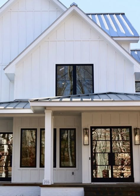 White board and batten with black windows and those gorgeous black iron and glass doors😍 White Board And Batten With Black Windows, White Board Batten Exterior, White Cottage Black Windows, White Board And Batten Farmhouse, Board And Batten Siding With Black Windows, White Board And Batten Exterior Black Windows, White Board And Batten Exterior, House Black Windows, Georgia Farmhouse