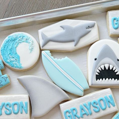 Utah Custom Royal Icing Cookies on Instagram: "Shark party! 🦈 🌊 . . . Inspo from @maddiescookieco #cookies #royalicing #royalicingcookies #victoriascookiecompany #customsugarcookies #sugarcookies #utahcustomcookies #utahbaker #utahroyalicingcookies #decoratedcookies #cookieart #satisfying #mouthwatering #cookiedecorating #utahcookies #birthdaycookies #eventcookies #utahcountycookies #sharkcookies #sharkweek #oceancookies" Shark Theme Cookies, Shark Sugar Cookies Royal Icing, Jaws Cookies, Shark Week Cookies, Shark Cookies Decorated, Shark Birthday Cookies, Shark Sugar Cookies, Ocean Cookies, Cutout Cookie