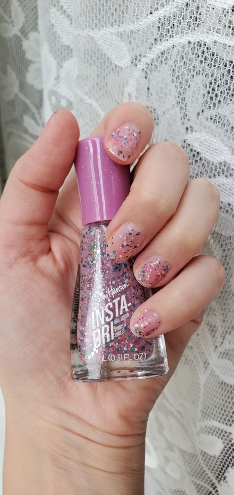 Hand holding bottle of nail polish Sally Hansen Nail Polish Colors, Purple Confetti Nails, Flakie Nail Polish, Glitters Nailpolish, Sally Hansen Pink Nail Polish, Confetti Nail Polish, Sprinkle Nails, Sally Hansen Nail Polish, Orly Nail Polish Confetti