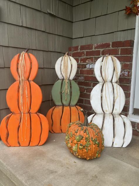 Ready for Fall?  These stacked pumpkins are great for your outdoor porch or indoor decor.  Made from solid 3/4" pine wood, glued, nailed together, and stained by hand.  They are distressed for a vintage look or solid finish and then polyurethane to protect from the elements.  They are designed with a folding easel leg for standing and easy storage.  They are available in a solid stack of all orange or all white or all green or all black, or you can order the three color stack white, green and orange. If you would like your pumpkin stack to be custom colors, please order the multi colored stack. Once I receive the order, I will contact you for your color combinations and I will make it your way.   The colors that I use are orange, white, green, black, yellow, blue and pink.  Start with the Pumpkin Porch, Outdoor Fall Decor, Fall Wood Crafts, Porch Pumpkins, Pallet Patio Furniture, Halloween Wood Crafts, Wood Snowman, Craft Booth Displays, Wooden Snowman