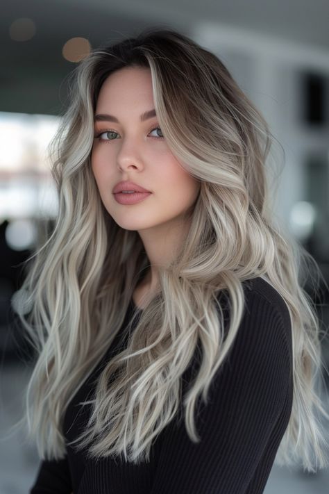 Young woman with long, wavy blonde hair and a black top, looking at the camera. Blonde Brown Ash Hair, Platinum Blonde Balayage Ombre Ash Brown Hair Color Ideas, Brown Hair With White Balayage, Ashy Highlights On Light Brown Hair, Brown Hair Ash Blonde Balayage, Ash Brown Hair Blonde Highlights, Light Blonde Balayage On Dark Hair, Ashy Blonde And Brown Hair, Ashy Blonde Balayage On Brown Hair