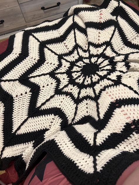 This blanket acrylic is made by me into a twelve point star that is webbed to look like a cob web blanket. It is a great size. It's very soft and warm. Cozy to cuddle up in. Crochet Spiderweb Blanket, Spider Web Crochet Blanket, Crochet Blanket Halloween, Crochet Spider Web Blanket, Gothic Crochet Blanket, Goth Crochet Blanket, Skull Crochet Blanket, Spooky Crochet Pattern, Checkered Crochet Blanket