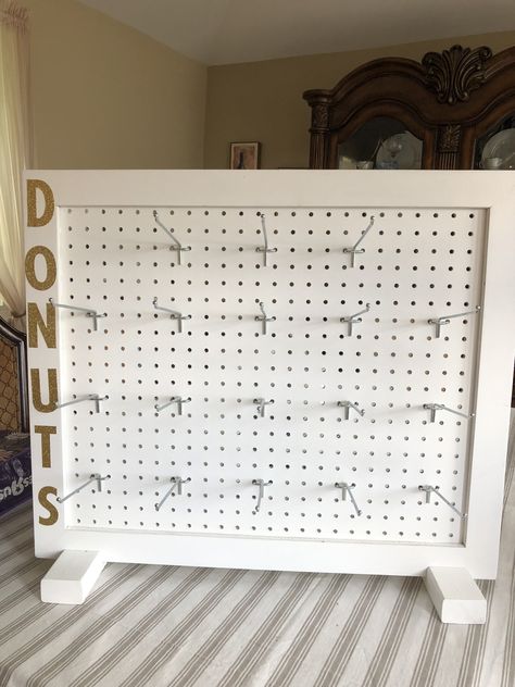 Donut wall made from peg board. Peg Board For Jewelry Display, Peg Board Table Display, Peg Display Board, Pegboard Jewelry Display Diy, Diy Standing Pegboard Display, Peg Board Keychain Display, Pegboard Keychain Display, Scrunchie Board Display, Peg Board Craft Show Display