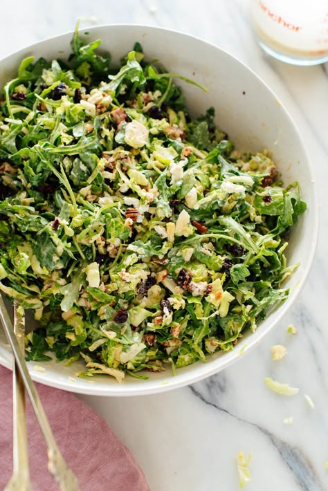 This shredded Brussels sprout and arugula salad is crisp, refreshing and filling! Enjoy this simple recipe for dinner, pack it for lunch tomorrow, make it for the holidays! #brusselssprouts #arugula #fallsalad #saladrecipe #cookieandkate Vshred Recipes, Orzo Arugula Salad, Sunshine Dressing, Sunshine Salad, Shredded Brussels Sprouts, Arugula Salad Recipes, Shredded Brussel Sprouts, Recipe For Dinner, Brussels Sprout