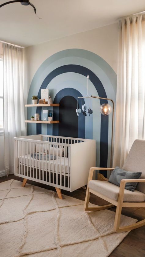 A minimalist nursery with a blue rainbow accent wall, white crib, and cozy decor. Rainbow Baby Nursery Ideas, Baby Boy Nursery Ideas, Boy Nursery Ideas, Baby Nursery Ideas, Rainbow Baby Nursery, Rainbow Mural, Nursery Idea, Nursery Trends, Minimalist Nursery