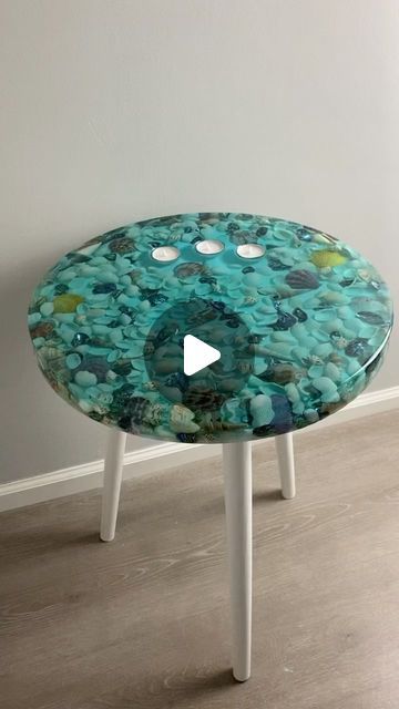 Jennifer Chapman on Instagram: "You’ve seen my shell tables before but this one as some extra sparkle. My lovely customer asked if I could add some abalone shell pieces into it too. I love when you walk past the table and the abalone shimmer.   @totalboat fathom resin and tabletop resin  @craftedelementsco silicone mold  #inart #ocean #oceanart #turquoise #shells #stones #waves #beach #calm #vacation #resin #resinart #epoxy #epoxyresin #coastline #tropical #stonesbeach #tranqui #coastalart #oceanside #beachday #lakes #beachvibes #paradise #candles #candleholder #tealights #summervibes #tranquility #sidetable" Resin Side Table, Resin Table Top, Waves Beach, Clear Epoxy Resin, Resin Table, Coastal Art, Ocean Art, Beach Scenes, Table Tops