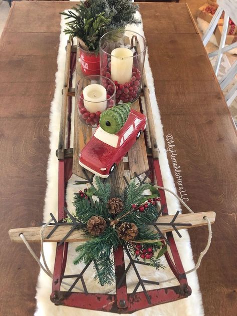 old sled on top of a dining table used as a decorative centerpiece | Diy christmas table, Christmas sled decoration, Christmas coffee table decor Decorating Sleigh For Christmas, Sleigh Decorations, Christmas Sled Decoration, Christmas Sleigh Decorations, Christmas Coffee Table, Sled Decor, Xmas Centerpieces, Christmas Coffee Table Decor, Diy Christmas Table