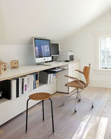 Need space for a home office? Look to your attic. These homeowners made great use of the space under the sloping ceiling with a long, low desk that includes shelving underneath. Clean lines, simple stripped flooring, and white walls and furniture make this space bright and cheerful. Slanted Ceiling Office, Deco Action, Attic Office, Attic Renovation Ideas, Attic Playroom, Loft Conversions, Loft Office, Small Attic, Loft Ideas