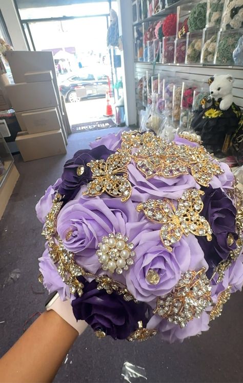 This silk flower bouquet is designed specifically for Quinceañeras, adding a touch of elegance and tradition to the special celebration. Crafted with high-quality silk flowers, it will beautifully accentuate the attire of the Quinceañera and serve as a lasting keepsake. Gold And Purple Dress, Quinceanera Flowers, Quince Stuff, 20th Bday, Silk Flower Bouquet, Gold Bouquet, Makeup Images, Silk Flower Bouquets, Quince Ideas