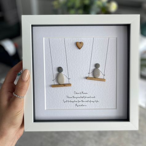 "☆ I have many other designs to choose from so be sure to check out my shop before ordering.  https://www.etsy.com/uk/shop/SherbetDesignsArt ☆ This artwork is handcrafted using natural pebbles and driftwood. Each art piece is made to order with your own personalised details which makes it a lovely gift for any occasion.  ☆ Please specify your wording in the personalised section when purchasing as all the text in the photos are just examples and do not come as standard. The exact wording on your order will be printed.  ☆ All pebble pictures are set in a 8\" x 8\" box frame with a glass front. It can be hung on a wall or placed to stand on a shelf or table. You can choose between a white, grey or light wood frame.  ☆ Please note the pebbles and driftwood will naturally differ to the photogra Rock Frames Stone Art, Diy Gifts With Pictures, Pebble Rock Art, Rock Crafts Diy, Pebble People, Rock People, Friendship Presents, Seashell Frame, Stone Artwork