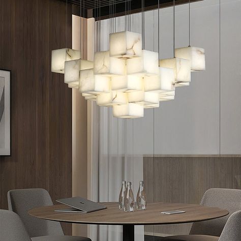 [FEATURE] 
 This Pendant Light is an exquisite and elegant hanging light fixture that features a white color tone. Its uniqueness lies in the design of the lampshade, which is composed of multiple boxes. Each box is meticulously crafted from plaster material, creating an artistic geometric shape that brings a distinctive play of light and shadow to the indoor space Alabaster Box, Chandelier Lighting Modern, Marble Box, White Light Fixture, Box Light, Luxury Marble, Lighting Modern, White Box, Hanging Light