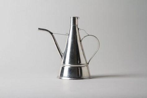 Purists insist that olive oil must be stored away from light and heat. Here are 10 containers that keep your liquid gold safe from both. Metal Above: Made Olive Oil Container, Plant Watering Can, Kitchen Guide, Mitchell Gold, Liquid Gold, Ceramic Tableware, Organization Solutions, Table Of Contents, Olive Tree