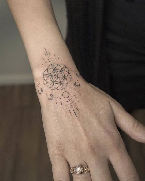 Hand poked flower of life and moon phases tattoo on the Moon Phases Hand Tattoo, The Flower Of Life Tattoo, Sacred Geometry Hand Tattoo, Coldplay Tattoo Symbol, Life Flower Tattoo, Flower Of Life Neck Tattoo, Sacred Geometry Tattoo Women, Seed Of Life Tattoo, Sacred Geometry Tattoos