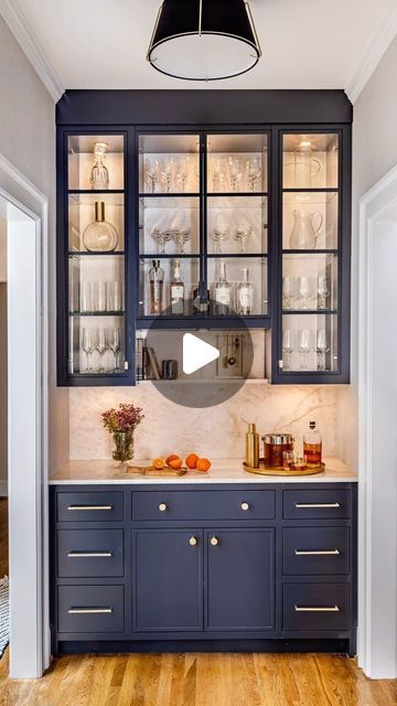 Terracotta Design Build on Instagram: "In this butlers pantry, the details make ALL the difference! Here’s why:
.
It’s a small space, so taking the upper cabinets all the way to the ceiling draws your eye up and makes it feel bigger!
.
Thinner profile on the glass doors and glass shelves instead of wood create lightness and openness. 
.
Continuing the subtly shimmery wallpaper into the back of the cabinets creates visual continuity, as does using the same stone on the countertop, backsplash, and feature shelf. 
.
Raising the middle cabinet up to create a small display shelf gives just enough variation of shape to keep things interesting. 
.
Moving the beverage refrigerator to the kitchen allows for elegant and eye-pleasing symmetry. 
.
In-cabinet and under-cabinet lighting shows off  a shi Shimmery Wallpaper, Glass Cabinets Kitchen, Small Display Shelf, Terracotta Design, Countertop Backsplash, Butlers Pantry, Beverage Refrigerator, Glass Cabinet Doors, Butler's Pantry