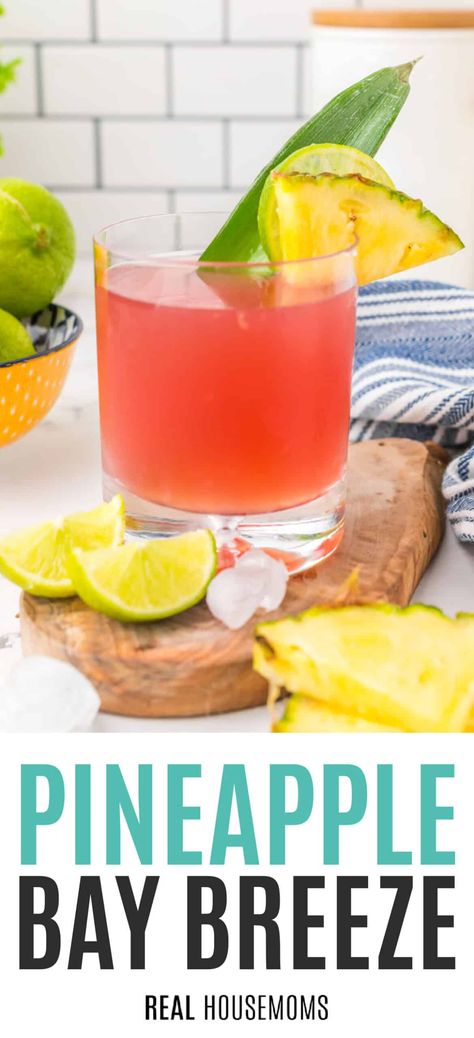 Fresh and fruity Pineapple Bay Breeze is a perfect mix of pineapple, cranberry, and orange shaken with ice and finished with a twist of lime! #RealHousemoms #baybreeze #pineapple #rum #cranberryjuice #orangejuice #cocktail #drink #mothersday #girlsnight Blushing Bride Drink, Cocktail With Pineapple Juice, Fireball And Pineapple Juice, Vodka And Pineapple Juice Cocktails, Pineapple Breeze Drink, Pineapple Rum Drinks, Drinks With Pineapple Juice, Pineapple Infused Vodka, Cranberry Drinks