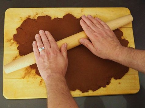 It's so simple to make these long-lasting holiday "cookie" decorations; using only 3 ingredients that you probably have in your pantry already. It's only one small step further to turn them into a sweet-smelling garland that will charm for years to come. Mix together 1 full cup of cinnamon, 3/4 cup of applesauce, and 2 tablespoons of Elmer's Glue. Start with a wooden spoon, but eventually you'll want to thoroughly knead the dough with your hands to be sure that everything is evenly Cinnamon Stars Ornaments, Galvanized Tree Collar, Cardboard Gingerbread House, Cinnamon Applesauce, Deco Mesh Garland, Cinnamon Ornaments, Cookie Decorations, Christmas Wax Melts, Easy Holidays Crafts