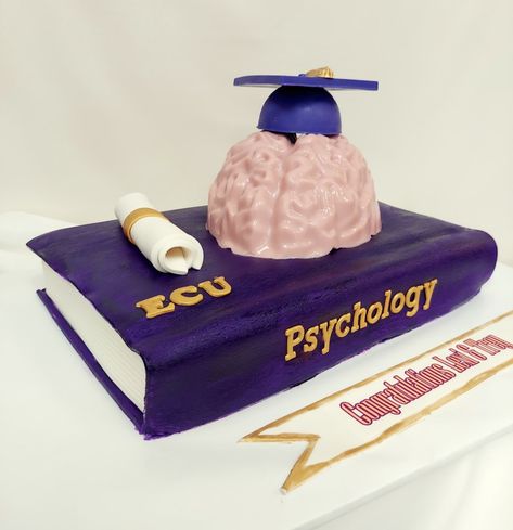 This cake is perfect for the Psychology major graduate. Book is cake, brain and cap are chocolate. #graduation #customcakes #Psychology #adcbakery #jacksonvillenc #americandreamcakes Bridgeton Cake, Chocolate Graduation, Graduation Cap Decoration Diy, Psychology Major, Grad Ideas, Cap Decoration, Psychology Student, Graduation Cap Decoration, Graduation Cake