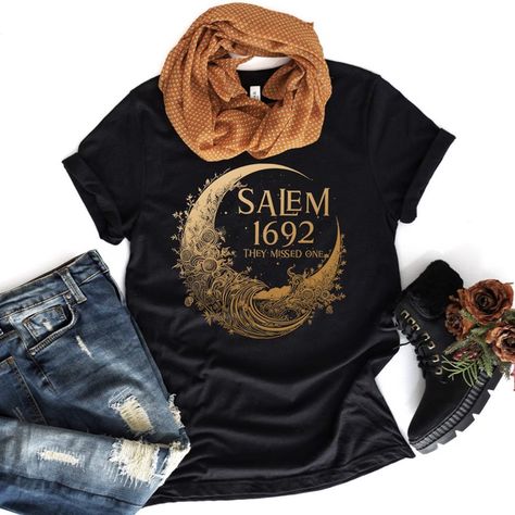 ✪ Salem 1692 They Missed One shirt ✪ Ideal for history enthusiasts, Salem visitors, or those intrigued by the moon's allure, our shirts offer gateways to understanding, dialogue, and a shared admiration for history's enigmas. Immerse yourself in Salem's moonlit mysteries. Choose your Salem 1692 Shirt and embody the allure of history. • Crafted with premium, comfortable fabric • Designs that honor the moonlit history of Salem • Available in various styles, sizes, and colors 1692 They Missed One, Salem Outfits Fall, 1692 Salem, Salem Halloween, Salem Massachusetts, Salem Witch, Halloween Tshirt, Witch Outfit, Fabric Designs