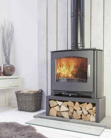 Stove stands and log boxes, stove installation accessories Wood Stove Stand, Wood Burning Stove With Wood Storage, Freestanding Wood Stove Living Rooms, Raised Wood Stove, Wood Heater Ideas Living Rooms, Free Standing Log Burner Living Rooms, Corner Log Burner Ideas, Modern Log Burner, Wood Stove Hearth Ideas