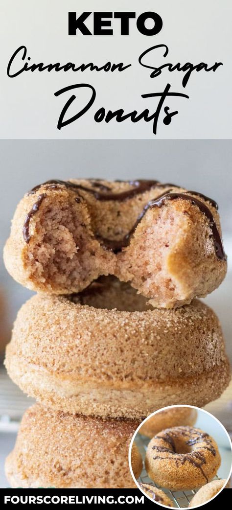 Three homemade donuts staked on top of each other covered in cinnamon sugar. The top one is drizzled with chocolate