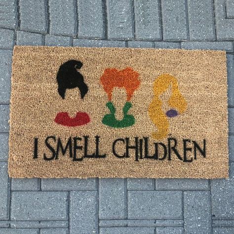 This 'Hocus Pocus' Merch Will Have You Running Amuck on Halloween Halloween Porch Decorations Diy, Halloween Decorations To Make, I Smell Children, Halloween Door Mat, Halloween Porch Decorations, Cricut Halloween, Sanderson Sisters, Halloween Porch, Fall Halloween Decor