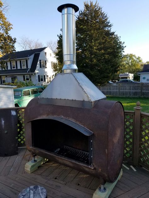 Heating oil tank repurposed into an outdoor fireplace. Repurposed Oil Tank, Oil Tank Fire Pit, Metal Outdoor Fireplace, Oil Tank Ideas, Diy Heater, Outdoor Wood Fireplace, Diy Outdoor Fireplace, Outdoor Fireplace Designs, Fireplace Set