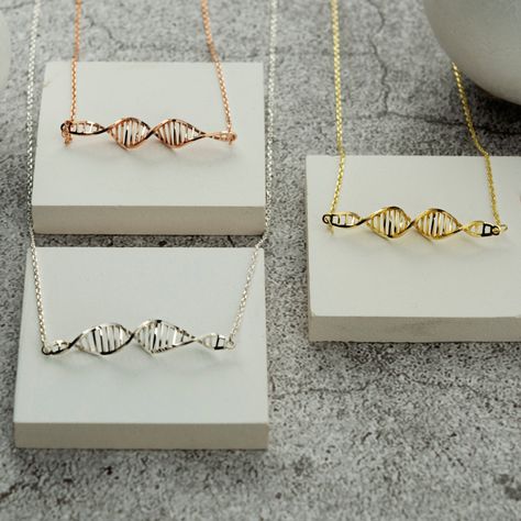 Discover the elegance of All Uniqueness with our handcrafted DNA necklace. This exquisite piece will illuminate your style with its sparkling charm. Ideal for medical professionals, students, or anyone passionate about science, it makes a thoughtful gift for loved ones. Perfect for graduations, this necklace can be personalized with letters for a truly unique touch. Celebrate the beauty of medicine and science with this meaningful gift. Technical Details: - Chain length: 16+2 inches (40+5cm) - P Dna Necklace, Dna Earrings, Dna Jewelry, Molecule Necklace, Personalized Wedding Rings, Science Jewelry, Engraved Wedding Rings, Engraved Engagement Ring, Design Box