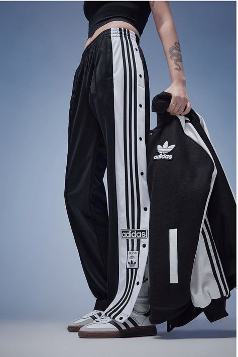 Make Your Daily Style Stand Out With These Women's Adibreak Track Pants From Adidas Originals. In A Black Colourway, These Mid-Rise Pants Are Made From Smooth Recycled Polyknit Fabric To Keep Them Lightweight. They Feature An Elasticated Waistband With A Drawcord Tie, While The Snap-Button Legs Offer A Verstaile Fit. With Secure Side Pockets For Your Essentials, These Pants Are Finished Off With The 3-Stripes And Retro Adidas Trefoil Branding. Machine Washable. | Our Model Is 5'6" Adidas Side Button Pants Outfit, Adidas Pants Woman, Sports Wear Womens Casual, Adidas Tracksuit Pants, Adibreak Pants Outfit Women, Y 3 Adidas, Pants With Buttons On Side, Adidas Clothes Women, How To Style Track Pants