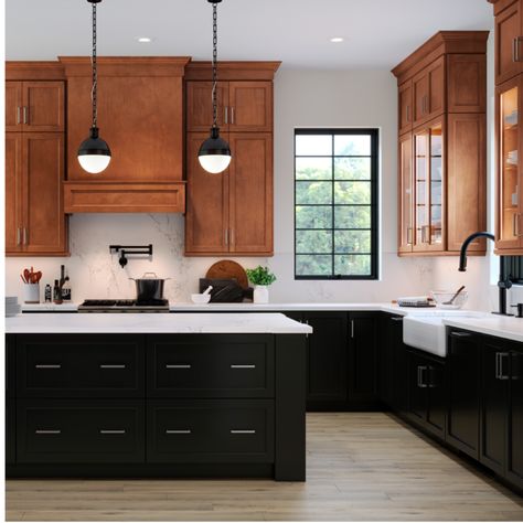 Black can be warm and welcoming, especially used as an accent color with a wood-tone finish. Try rich maple cognac upper cabinets paired with painted black lower cabinets and a painted black island. #waypointlivingspaces #kitchencabinets #cabinets #remodel #kitchendecor #kitchenstyle #kitchenideas #blackcabinets Wood Upper Painted Lower Cabinets, Kitchen Wood And Black Cabinets, Kitchen Black Lower Cabinets, Black Appliances With Wood Cabinets, Black Kitchen Island Brown Cabinets, Maple Kitchen Cabinets With Black Island, Dark Upper Kitchen Cabinets, Brown And Black Cabinets Kitchen, Black Lowers White Oak Uppers