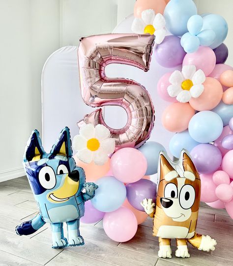 Welcome to Sweet Escapes By Debbie  Make your Bluey-themed party extra special with our Bluey and Bingo Balloon Garland! This colorful and fun balloon garland is the perfect addition to any celebration, bringing the beloved characters Bluey and Bingo to life.  Balloon towers are the perfect way to add that wow to your party. With helium prices increasing and sometimes hard to find this is the perfect balloon option filled with air! This kit includes everything you need to create your tower. This is a great accent or stunning centerpiece for your party. It is also great as a photo prop! Included in each DIY kit: Colors pink, matte blue, melon and blossom ~ 12 11" latex balloons ~ 3 balloon clips ~ One pink number ~ One 12" mylar daisy ~ Glue dots ~ Add on Bluey, Bingo or both! ~ (1) Dual ac Diy Bluey Centerpieces, Bluey Birthday Party Balloons, Bluey Birthday Party Girly, Blue And Pink Balloon Garland, Bingo Birthday Party Theme, Bluey Birthday Party Ideas Pink, Diy Bluey Birthday Decorations, Bluey Diy Party, Bluey Centerpiece Ideas