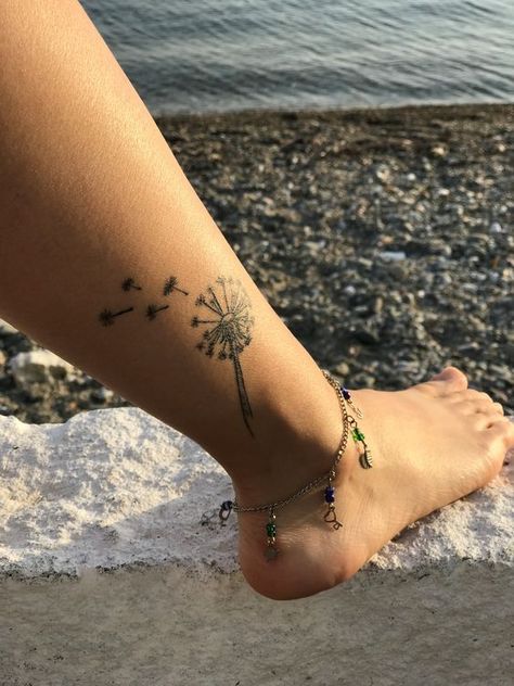 Make your life brighter with 62 completely unique and vivid dandelion tattoos! Bonus: reveal the tattoo’s meaning and where to get it. Dandelion Tattoo On Ankle, Dandelion Ankle Tattoo, Ankle Tattoo Designs Unique, Dandelion Tattoos, Tattoo Ideas Female Sleeve, Dandelion Tattoo Design, Wrist Tattoos Girls, Tattoo Leggings, Tattoo Designer