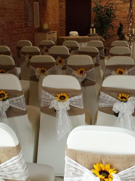 Beautiful hessian and lace chair sashes with bright sunflowers. www.elshamhallevents.co.uk Sunflower Themed Quinceanera, Wedding Sunflower Decorations, Quince Sunflower Theme, Sunflower Quince Theme, Wedding Decorations Sunflowers, Quinceanera Sunflower Theme, Sunflower Wedding Isles Decoration, Yellow Quinceanera Theme Decorations, Rustic Wedding Decor Sunflowers