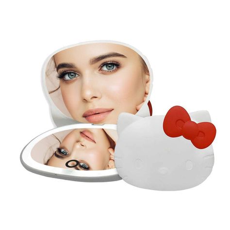 PRICES MAY VARY. 𝐂𝐔𝐓𝐄 𝐂𝐎𝐌𝐏𝐀𝐂𝐓 𝐌𝐈𝐑𝐑𝐎𝐑: This lighted makeup mirror features a Hello Kitty shape with her iconic red bow. This hand makeup mirror is an attractive piece that is perfect for your everyday use 𝐋𝐈𝐆𝐇𝐓𝐄𝐃 𝐌𝐈𝐑𝐑𝐎𝐑: This hello kitty shaped compact mirror features a bright LED light strip. It has a touch sensor on the mirror to turn the power on or off and hold to adjust the brightness 𝐌𝐀𝐆𝐍𝐈𝐅𝐘𝐈𝐍𝐆 𝐌𝐈𝐑𝐑𝐎𝐑: This face mirror is equipped with two mirro Vanity Hello Kitty, Hello Kitty Mirror, Face Mirror, Travel Makeup Mirror, Hand Makeup, Hello Kitty Videos, Hello Kitty Makeup, Portable Mirror, Impressions Vanity