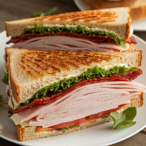 The ultimate Turkey Club Sandwich – triple-layered goodness with turkey, bacon, lettuce, and tomato! 🥪❤️ _____Ingredients:_____ - 3 slices of toasted bread (white or whole wheat) - 3 oz deli turkey breast - 2 slices of cooked bacon - 1 leaf of lettuce - 2 slices of tomato - 2 tablespoons mayonnaise - Salt and pepper to taste _____Directions:_____ 1. Toast all 3 slices of bread until golden brown. 2. Spread mayonnaise on one side of each slice of bread. 3. Layer the first slice of... Mayonnaise Turkey, Turkey Club Sandwich, Turkey Club, Deli Turkey, Toasted Bread, Club Sandwich, Turkey Bacon, Turkey Sandwiches, Whole Wheat Bread