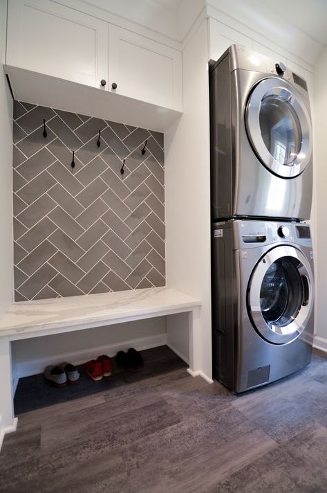 A cubby-bench sits next to the washer and dryer as the perfect drop zone for shoes, coats, and backpacks. Washer Dryer Laundry Room, Laundry/mudroom Ideas, Cubby Bench, Garage Laundry Rooms, Mudroom Cubbies, Custom Laundry Room, Stacked Laundry Room, Laundry Room Renovation, Drop Zone